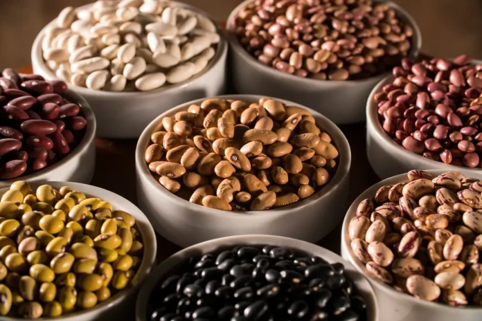 assorted-beans-bowls-wood-background-94205220